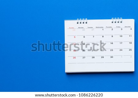 close up of calendar on blue background planning for business meeting or travel planning concept