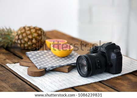 Professional camera and fruits on table. Food blog