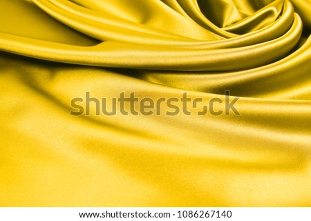 Beautiful smooth elegant wavy light yellow satin silk luxury cloth fabric texture, abstract background design. Copy space