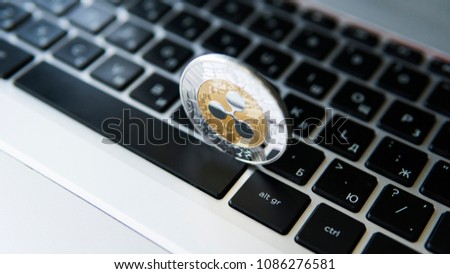 Silver gold ripple coin on a laptop keyboard closeup. Blockchain mining. Digital money and virtual cryptocurrency concept. Crypto currency investment. Digital money. Metal coins. Bussiness, commercial