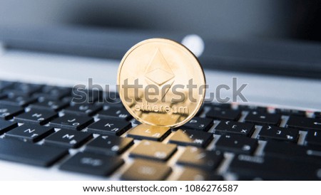 Gold Ethereum coin on a laptop. Ethereum crypto currency on a laptop black keyboard. Digital money and virtual cryptocurrency concept. Investment. Bussiness, commercial. Profit from mining.
