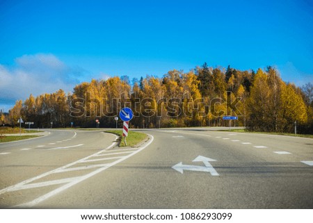 A view of the asphalt country road in Latvia on a clear autumn day