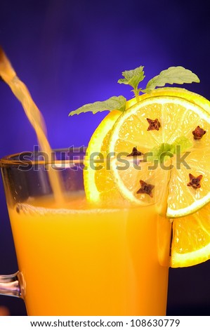 Hot orange juice in glass cup and spice