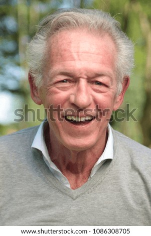 Beautiful old happy man outside