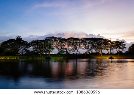 A small lake in summer , at sunset