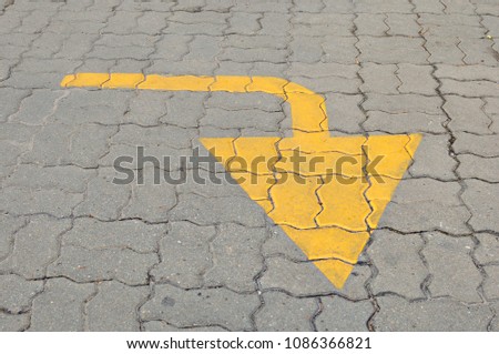 Yellow arrows help traffic, painted brick on the floor.