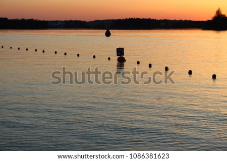 Buoys marks swimming area in fantastic sunset