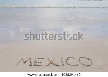 Vacation in Mexico. Inscription Mexico on the beach. Letters on the sand. Summer concept of sandy beach. Space for text