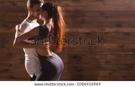 Active happy adults dancing bachata together in dance class Royalty-Free Stock Photo #1086416969