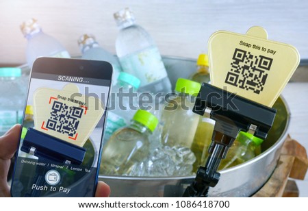 mobile payment online shopping concept,  hand holding smartphone scaning qr code for payment drinking water. Royalty-Free Stock Photo #1086418700
