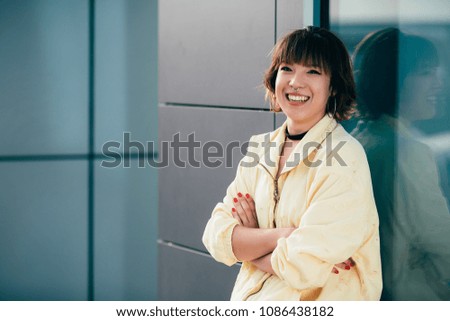 Portrait of happy young Asian girl in the street. Lifestyle concept