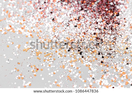 Color glitter on light background - macro photo