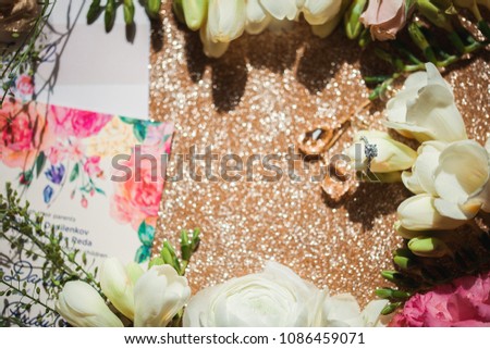 wedding ring with flowers on a gold backgraund