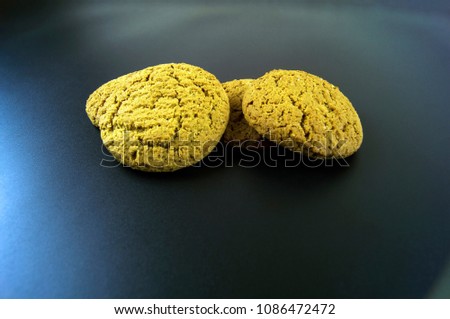 A few pieces of oatmeal cookies on a dark background