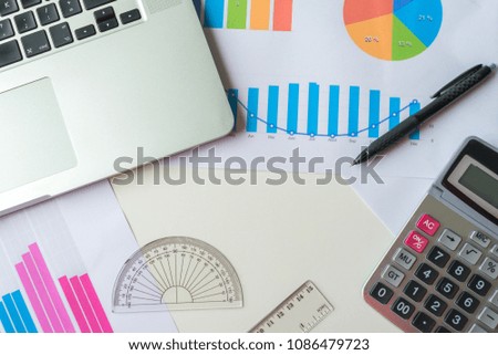 Financial and business graph with laptop and calculator