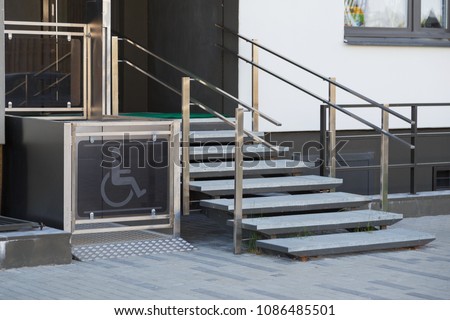 Living house entrance equipped with special lifting platform for wheelchair users Royalty-Free Stock Photo #1086485501