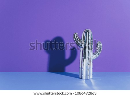 Creative golden cactus on ultraviolet background. Minimal concept art.