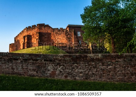 Chester Castle at sunset, beyond the city wall. The castle and the walls are one of the major tourist attraction of the City of Chester. Royalty-Free Stock Photo #1086509357