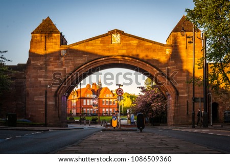 View through the Newgate, the newest gate in Chester city walls, looking towards the Chester Roman Amphitheatre, at sunset. Royalty-Free Stock Photo #1086509360