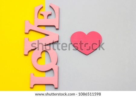 Wooden hearts on a multi-colored background, top view