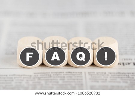The phrase faq on cubes on a newspaper