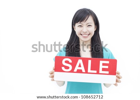 beautiful young woman showing SALE sign, isolated on white background