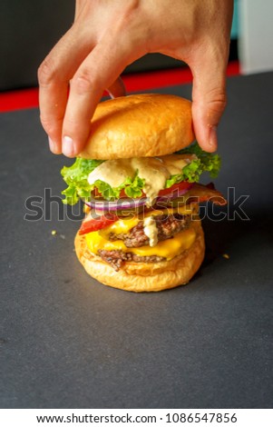 Chef's hand making a hamburger