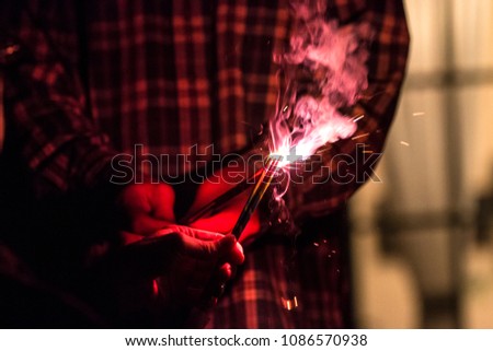 4th of July fireworks being lit off in the back yard, Royalty-Free Stock Photo #1086570938