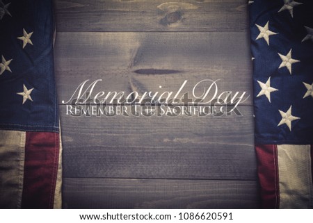 The flag of the United Sates of America on a grey plank background with memorial day