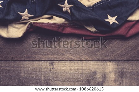 A vintage American flag or bunting on a wooden background with copy spacae
