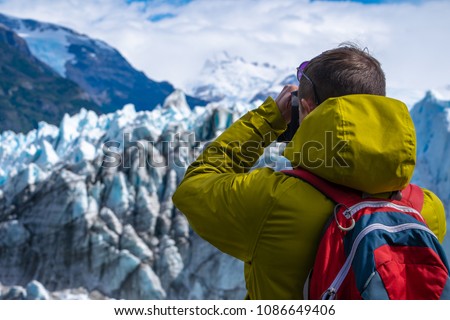 Photographer taking a picture of the ice of glacier. Perito Moreno Glacier, Los Glaciares National Park, Argentina