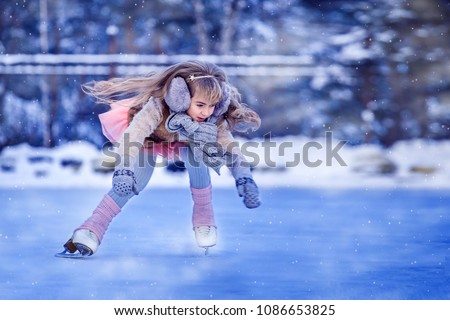 Girl on figure skates on a skating rink in a city park
