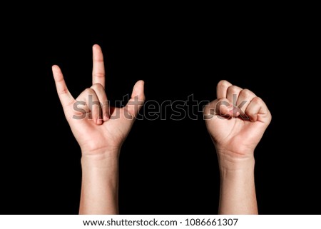 Hand sign of power and  love on black background