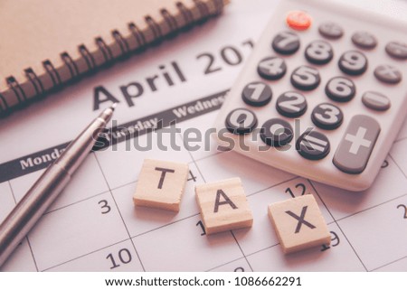Alphabet letter wooden blocks tiles. Tax text wooden block with on calendar page April month