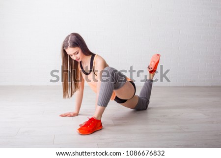 Young girl stretching on the floor and exercise