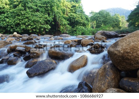 Calm water stream around the rocks.Picture taken in Chanthaburi Province. It is in the east of Thailand     