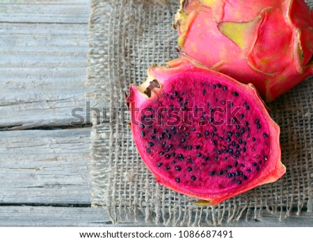 Fresh ripe Pitaya or Dragon fruit of the genus Hylocereus,Cactaceae family.
Pitahaya (Pitaya roja) red tropical exotic fruit on old wooden table.