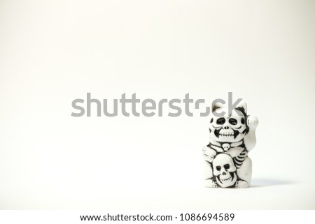 white skull bone head lucky fortune cat with white background	
