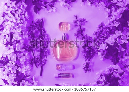 bottle with cosmetic fluid. branches with flowers.