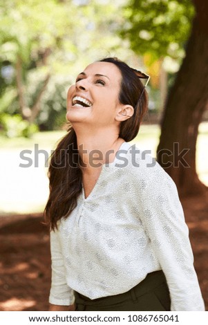 Laughing and carefree woman in park