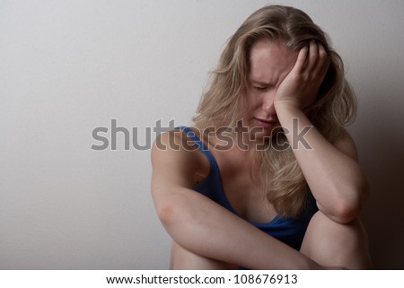 depressed young lonely woman girl, sitting on the floor alone and crying