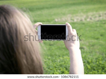 Close up of women's hands holding cell telephone with blank copy space screen for your advertising text message or promotional content