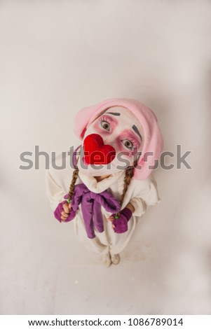 emotional girl funny posing at the camera. Human emotions in the image of a clown