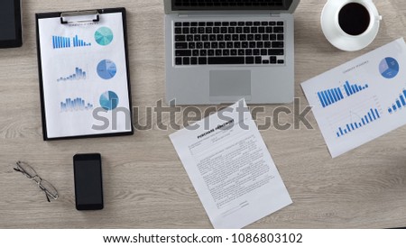 Purchase agreement lying on desk in boss office, business papers, top view