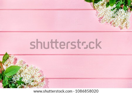 White flowers on pink wooden background. Place for text. The background for the text. White flowers on the corners of the picture. Flat Lay Top View Banner