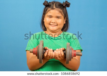 Asian women kid smile love sport exercise with dumbbell on blue background.