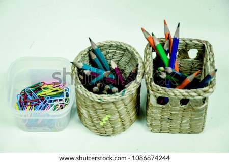 pencil , color pencils and paper clips in pots