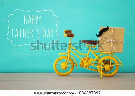 Image of metal yellow bicycle, present for dad. Father's day concept