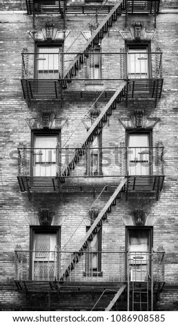 Black and white picture of fire escapes, one of the New York City symbols, USA.