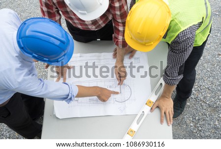 Group of civil engineer or architect, safety helmet and green reflective vest, working on construction site, blue print discussing, Real estate , construction industry and business concept. Royalty-Free Stock Photo #1086930116